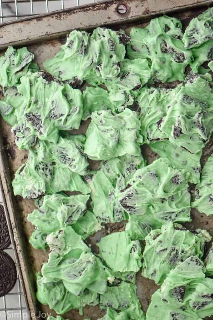 overhead of a baking sheet full of broken up pieces of mint Oreo bark