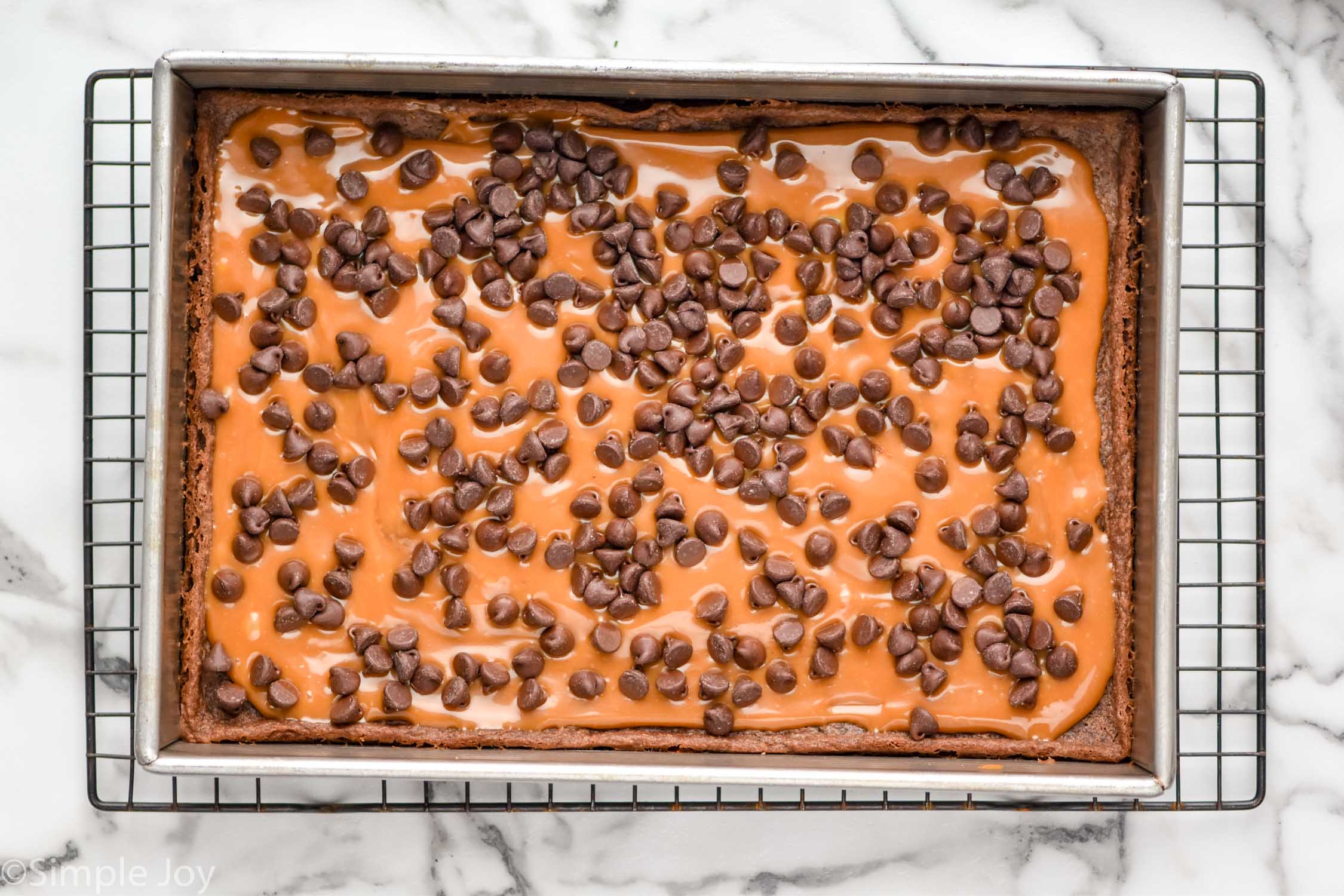 overhead of pan of caramel brownies on cooling rack