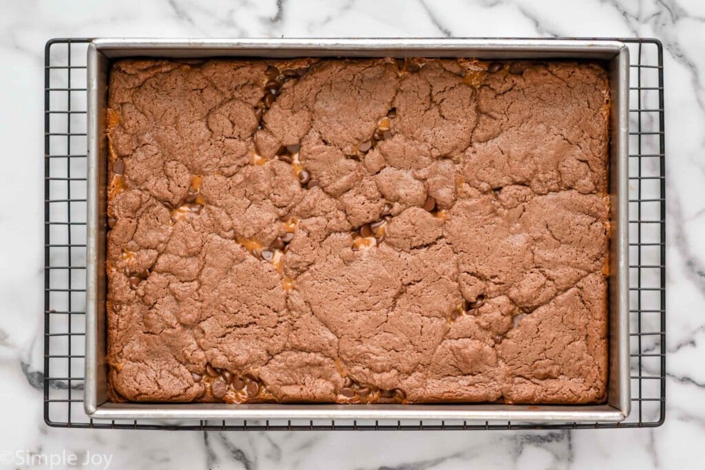 overhead of pan of caramel brownies on cooling rack