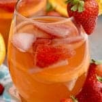 a close up glass of sangria with strawberries and oranges in it - 13