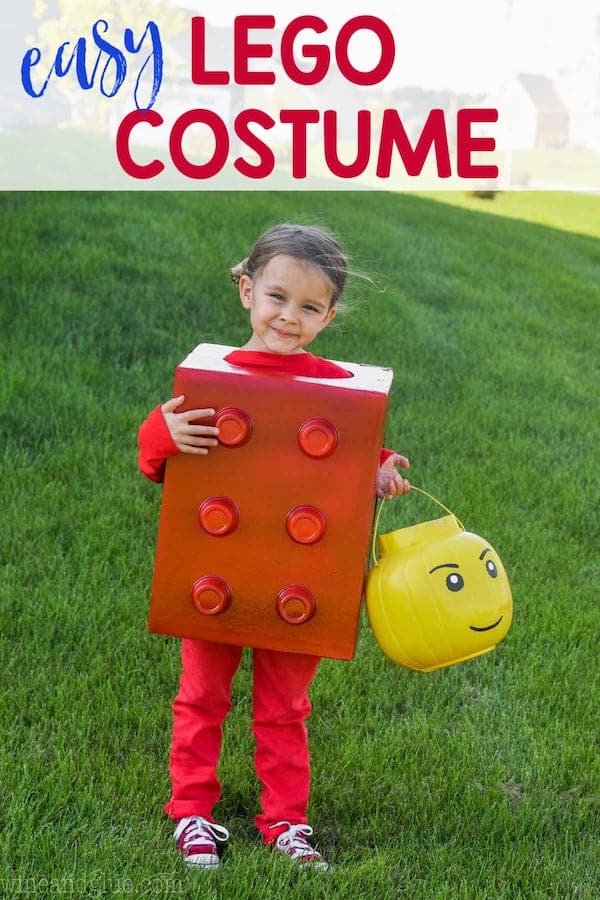 little girl wearing an easy halloween costume shaped as a lego