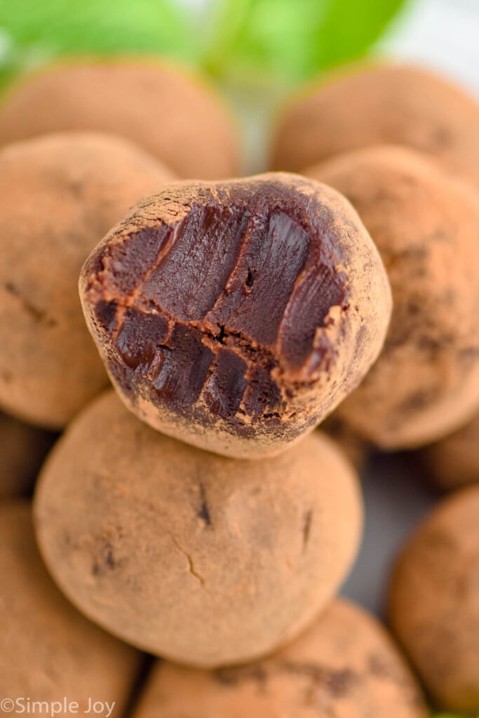 close up of chocolate truffles with a bite missing out of the top one