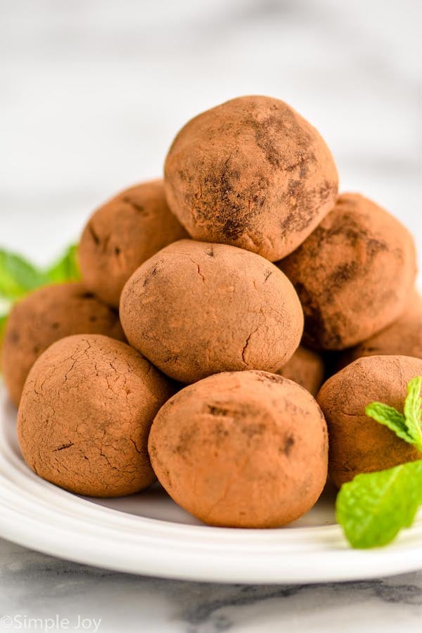 a pyramid of mint chocolate truffles on a white plate