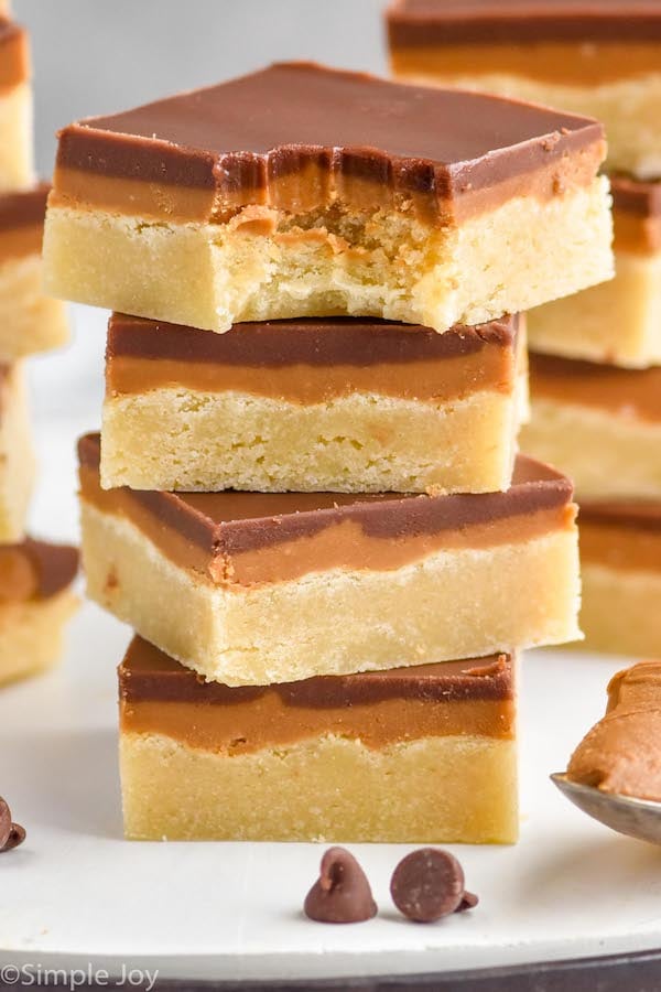 Photo of a stack of Cookie Butter Bars with a bite taken out of the top bar.
