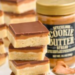 Pinterest graphic for Cookie Butter Bars recipe. Text says, "the best Cookie Butter Bars simplejoy.com." Image is photo of a stack of Cookie Butter Bars with a jar of cookie butter in the background.