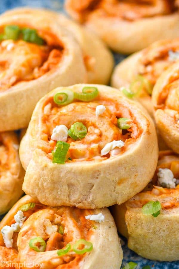 side view of a buffalo chicken pinwheels stacked on other pinwheels