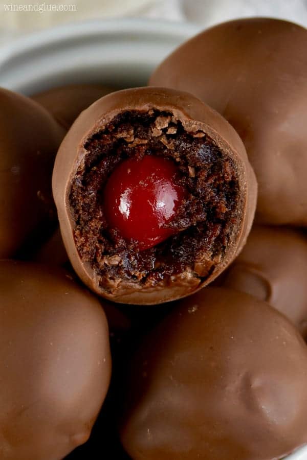 These Chocolate Covered Cherry Brownie Bombs are delicious bites of brownie surrounding cherries and then dipped in chocolate!  These are the perfect treat to make and give!