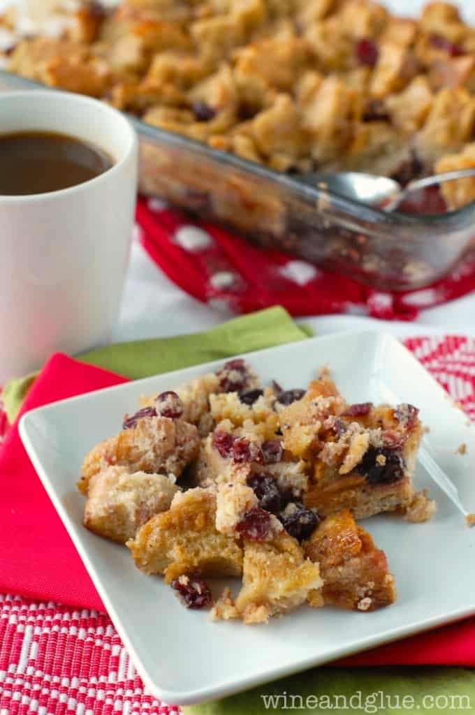 On a white plate, the Cranberry Stuffed French Toast has a crumbly texture and paired with a side of warm coffee. 