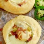 picture of a jalapeño popper pinwheel made with crescent roll dough, bacon, and pickled jalapeños