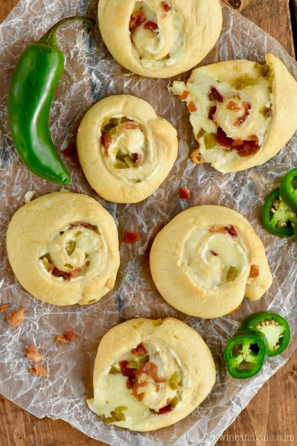 An overhead photo of the the Jalapeno Popper Pinwheels with melted cheese oozing out and minced bacon and jalapenos. 