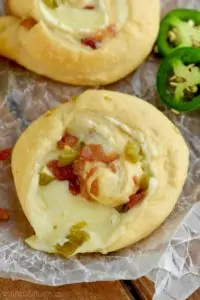 This Jalapeño Popper Pinwheels recipe is the best appetizer to bring to a party! Full of cream cheese, cheese, jalapeños, and bacon, they are absolutely delicious!