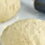 ball of pizza dough on a floured surface