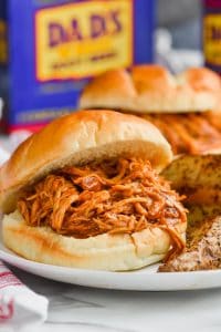 root beer slow cooker bbq chicken sandwich close up on a plate
