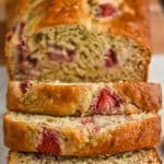 overhead view of strawberry banana bread sliced on a marble cutting board