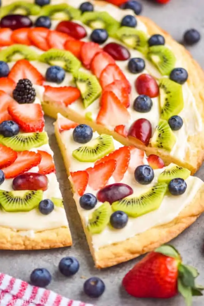 side view of a slice of sugar cookie fruit pizza