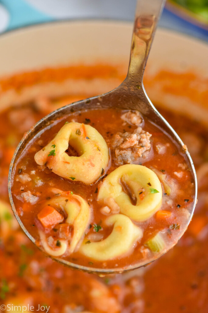 Overhead photo of Sausage Tortellini Soup in a ladle.