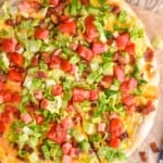 overhead of a blt pizza with one piece cut into - 8
