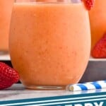 Pinterest graphic for Strawberry Mango Margaritas recipe. Image is close up photo of Strawberry Mango Margaritas garnished with sugar rims and strawberries. Text says, "Strawberry Mango Margaritas simplejoy.com"