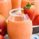 Close up photo of Strawberry Mango Margaritas garnished with sugar rims and strawberries. - 15