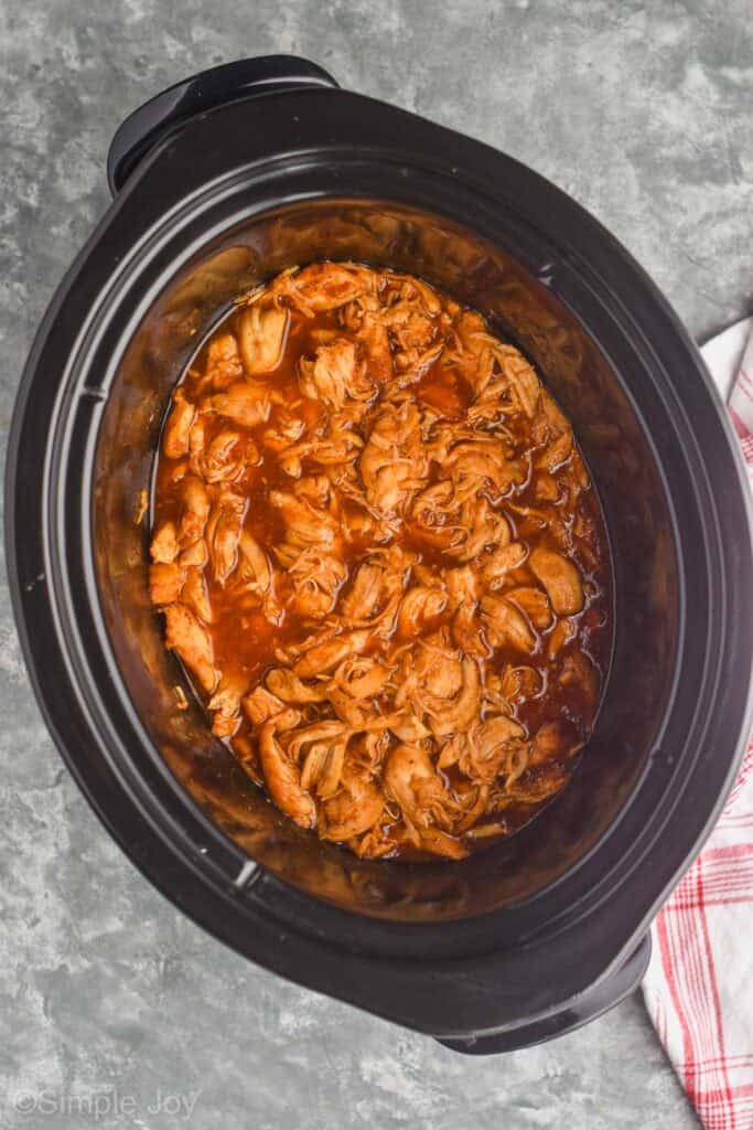 overhead view of crockpot shredded bbq chicken in a slow cooker