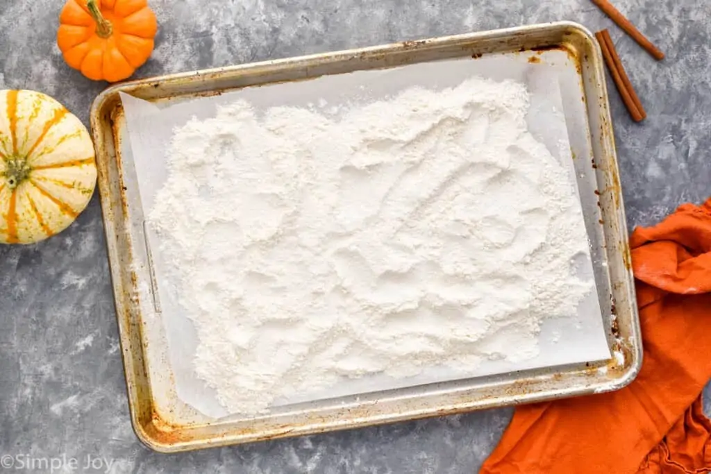 overhead of a baking sheet with parchment paper and flour