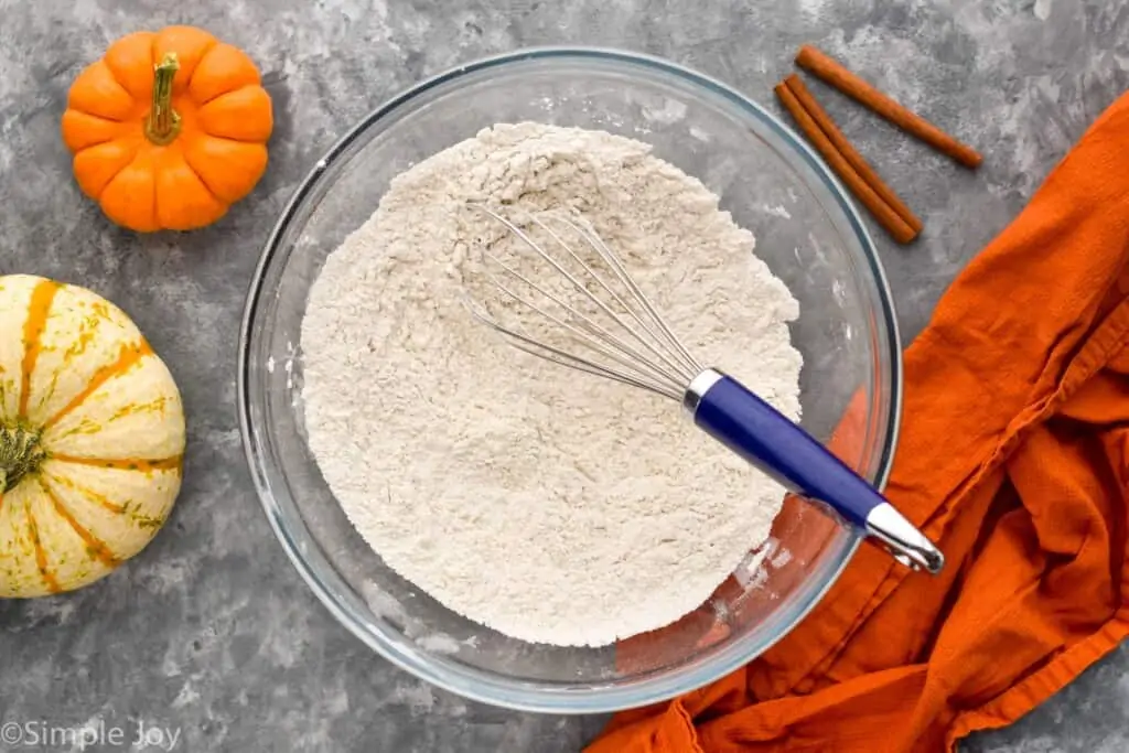 overhead of a bowl of flour and spices whisked together