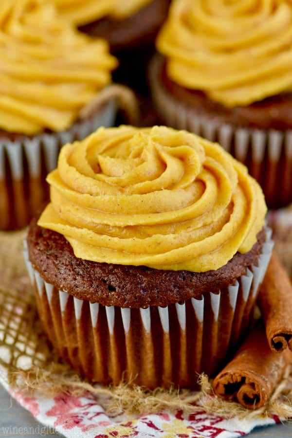 A chocolate cupcake pipped with the Pumpkin Buttercream by a star tip.