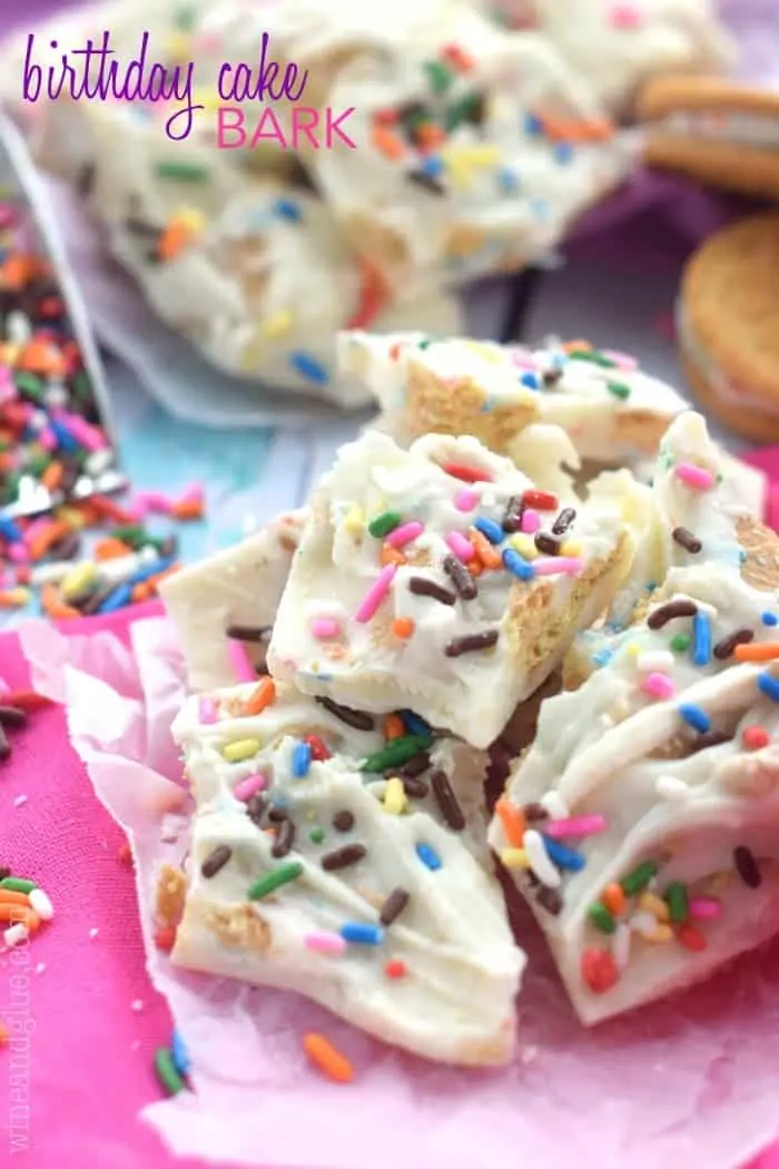 small pile of birthday cake bark made from white chocolate and topped with sprinkles, says “birthday cake bark”