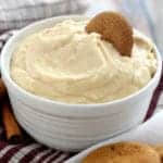 Small white bowl with eggnog dip, with a gingersnap, says: eggnog dip - 9