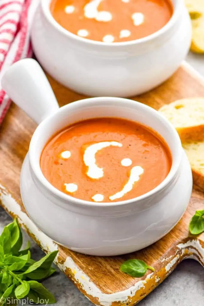 small soup bowl full of tomato bisque with cream drizzled on top