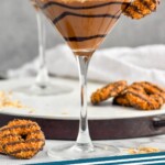 Pinterest graphic for Samoa Martini recipe. Image shows Samoa Martinis garnished with Samoa cookies. Extra Samoa cookies on counter. Text says, "Samoa Martini simplejoy.com"