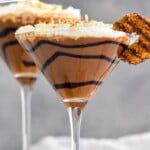 Pinterest graphic for Samoa Martini recipe. Text says, "the best Samoa Martini simplejoy.com." Image is photo of Samoa Martinis garnished with Samoa cookies. Extra Samoa cookies on the counter beside glasses.