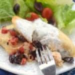 a fork digging into greek stuffed chicken - 7