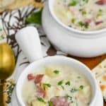 small white soup bowl full of new england clam chowder recipe and garnished with parsley