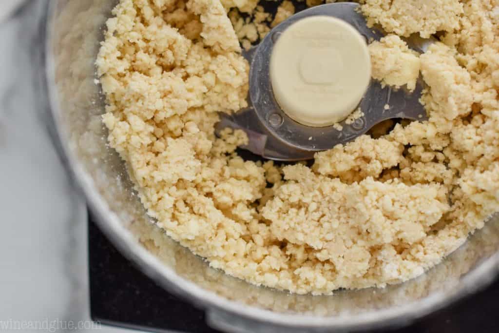 close up of the beginning of pie crust dough before the last bit of flour is added, mixture is crumbly, sizable chunks, and not pulled together - 20