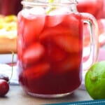 pinterest graphic showing a mason jar with a handle full of cherry limeade
