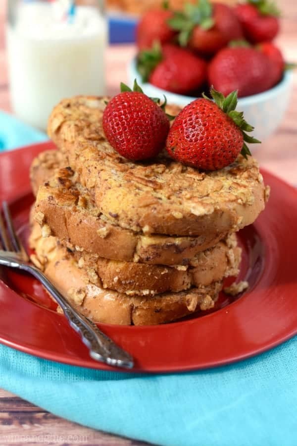 A stack of 4 Cinnamon Toast Crusted French Toast with two Strawberries on top