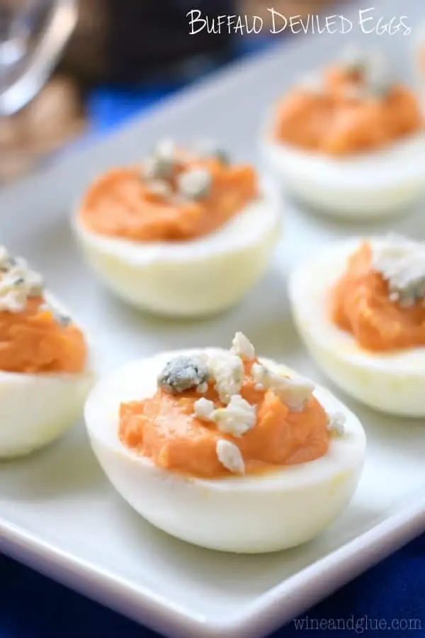 The Buffalo Deviled Eggs has a Buffalo Sauce coloring in the middle of the egg and topped with blue cheese. 