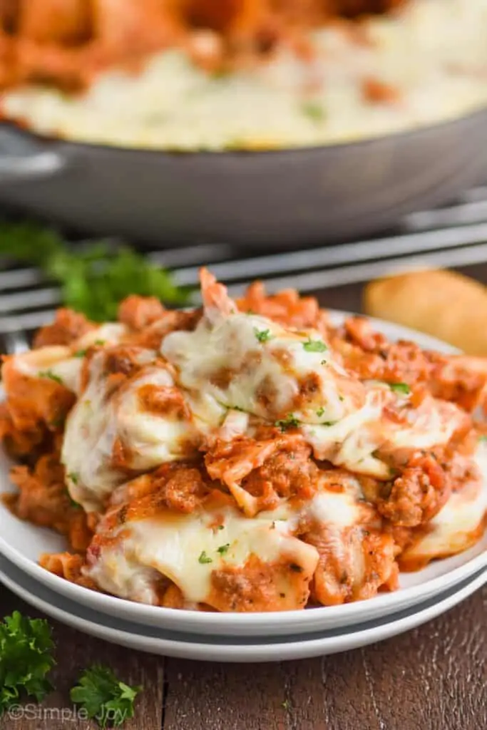 two small white plates with skillet lasagna on it