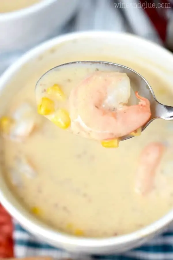 An overhead photo of the Spicy lShrimp Corn and Potato Bisque with a spoon showing the pink cooked shirmp and corn. 
