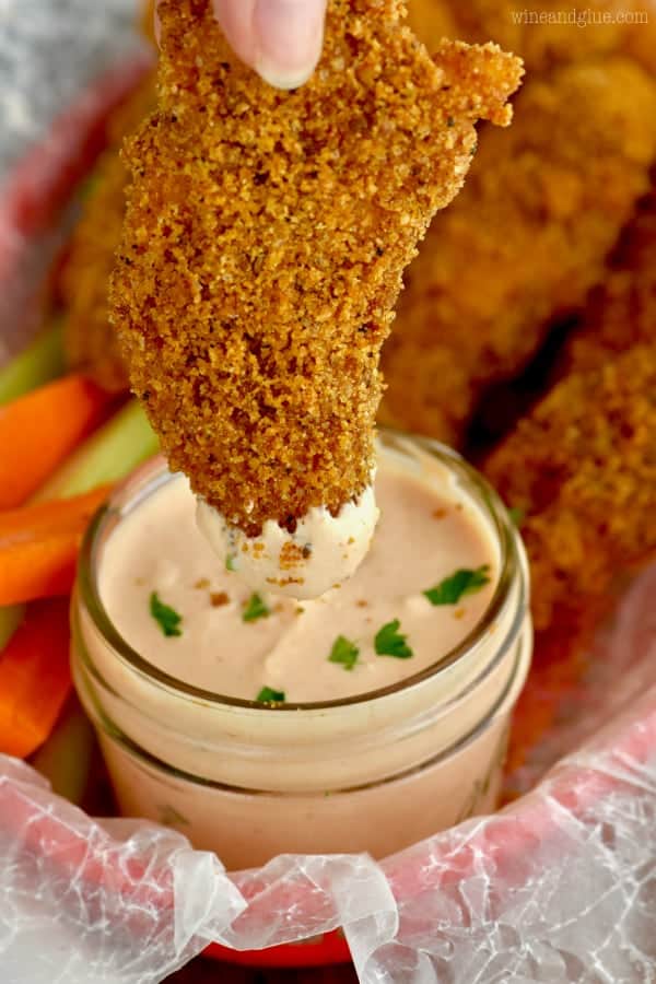 The Backed Chicken Tender is being dipped in the homemade dipping sauce