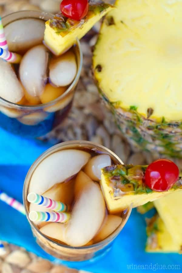 An overhead photo of two glasses with the Dirty Pina Colada Coke that has ice and two paper straws 