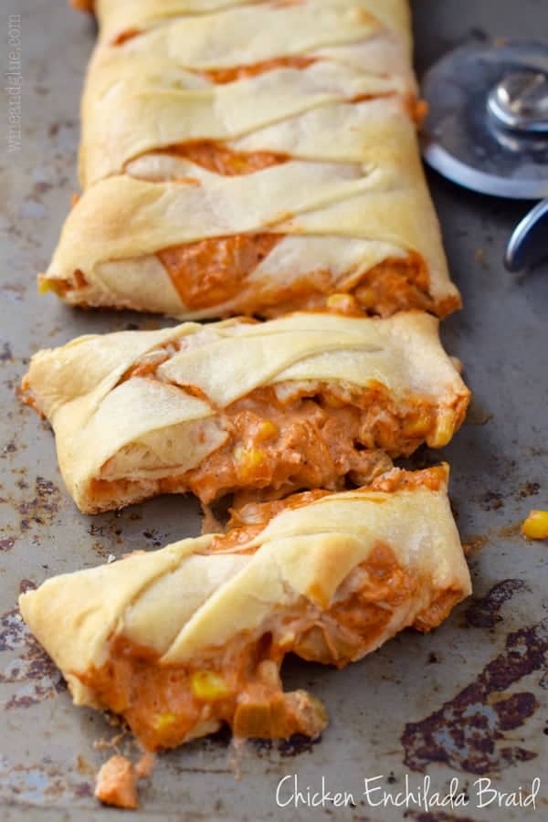 Chicken Enchilada Crescent Braid cut into strips on a pan with the filling oozing out. 
