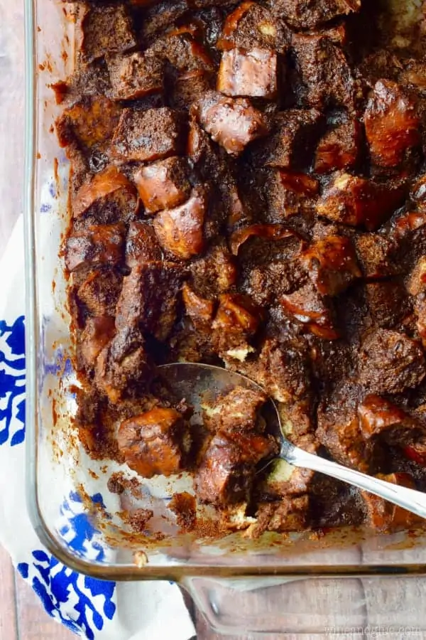An overhead photo of the Chocolate Pretzel Bread Pudding in a glass casserole dish which has layered with chocolate and bread chunks. 