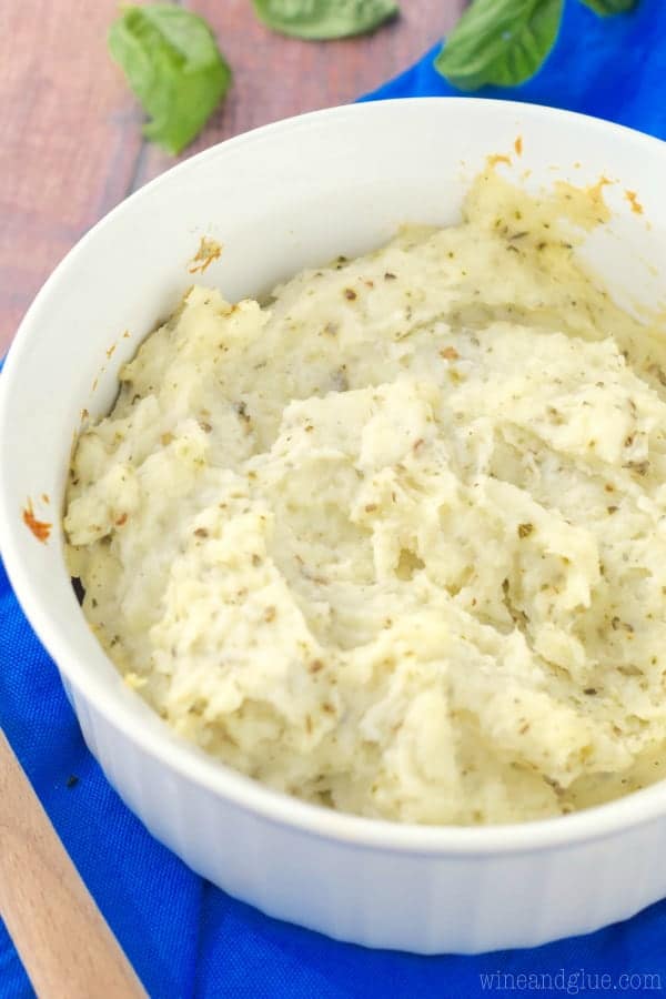The Italian Mashed Potatoes has a fluffy and creamy texture with speckles of green from the spices. 