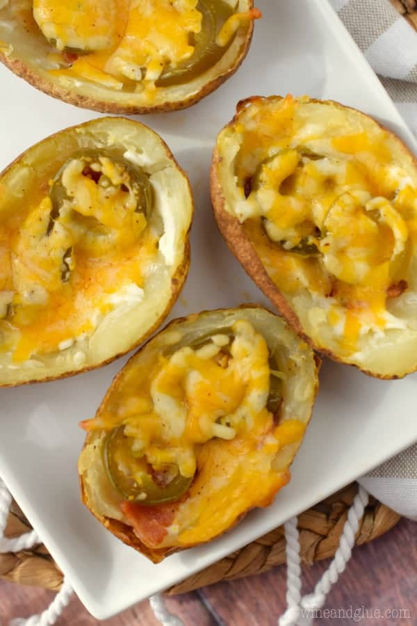 An overhead photo of the Jalapeno Popper Potato Skin showing the jalapenos and bacon under a sheet of melted cheese. 