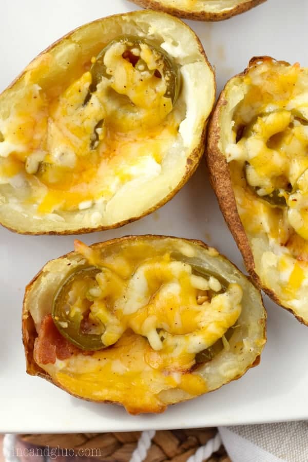 An overhead photo of the Jalapeno Popper Potato Skin showing the jalapenos and bacon under a sheet of melted cheese. 