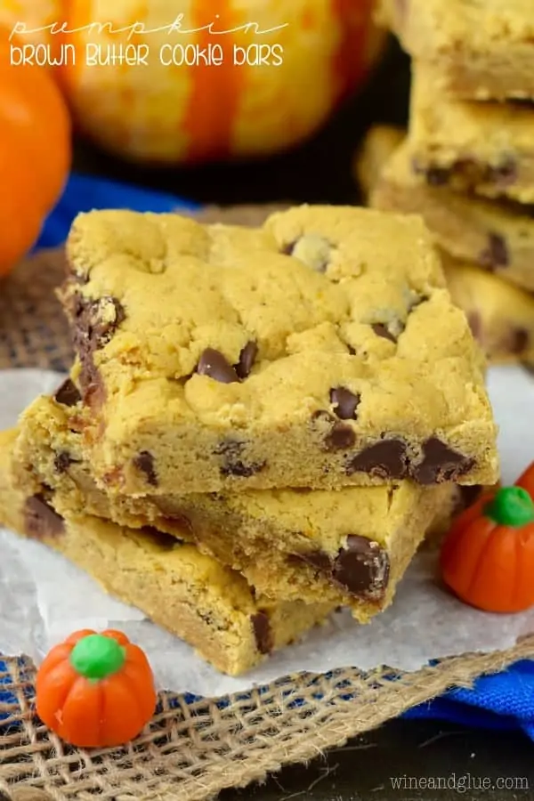 The Pumpkin Brown Butter Cookies Bars have a golden brown hue with melted chocolate chip cookies stacked on top of each other. 
