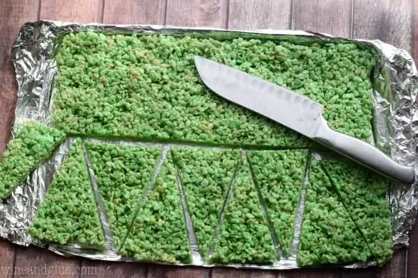 On a baking sheet, the green Rice Krispies was cut horizontally and then into little triangles. 