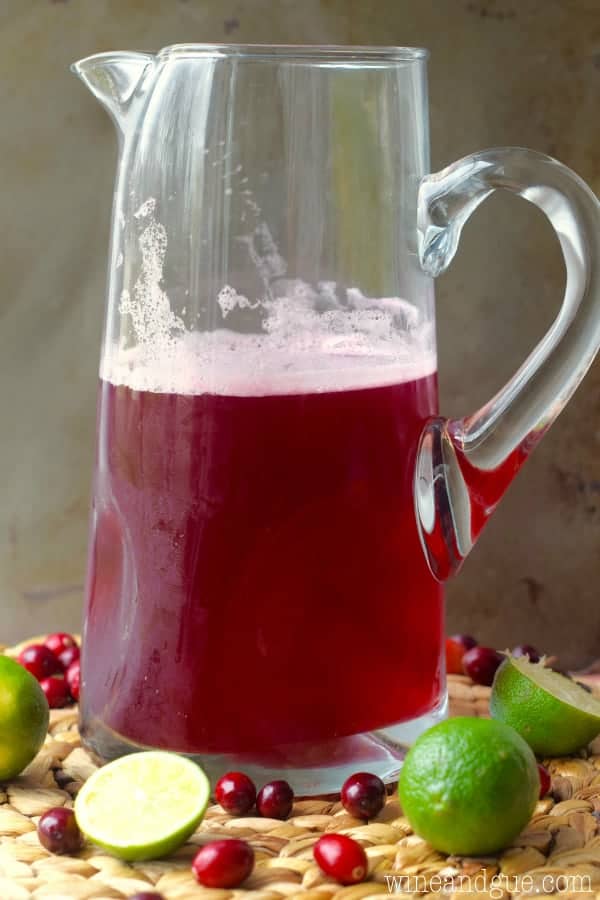 A large pitcher the Cranberry Beergaritas with a dark maroon color. 